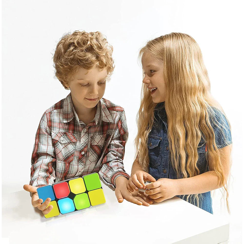 Two children exploring a handheld color-matching puzzle together at a table