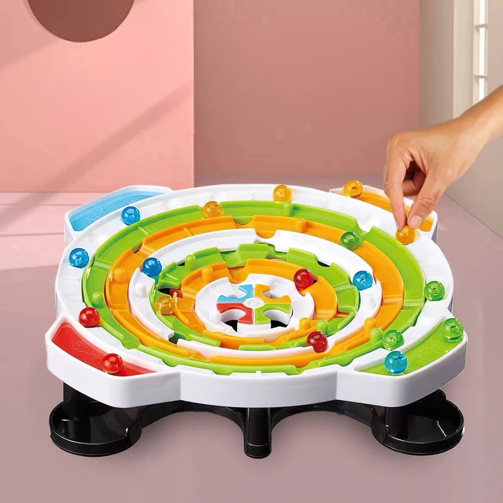 Circular ball maze with colored rings, matching balls, and black collection trays.