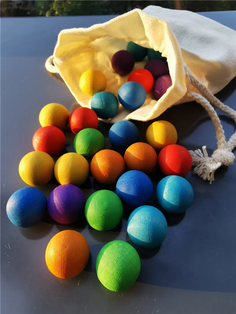 Colored wooden balls spilling from an open drawstring bag onto a table