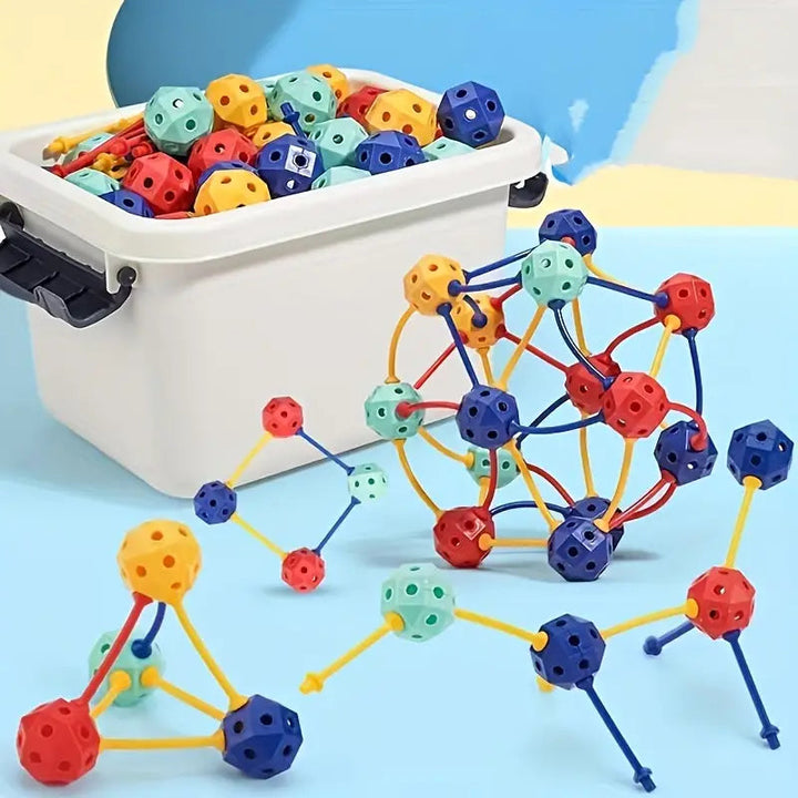 Colorful ball-and-stick building models beside a white storage box filled with pieces