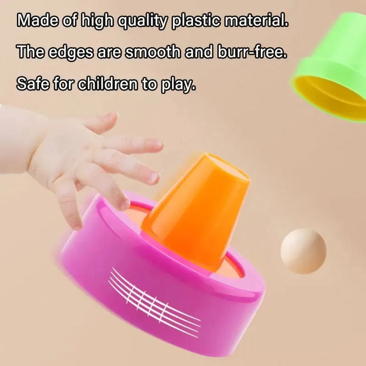 Close-up of colorful cups and a tilted pink stacking base