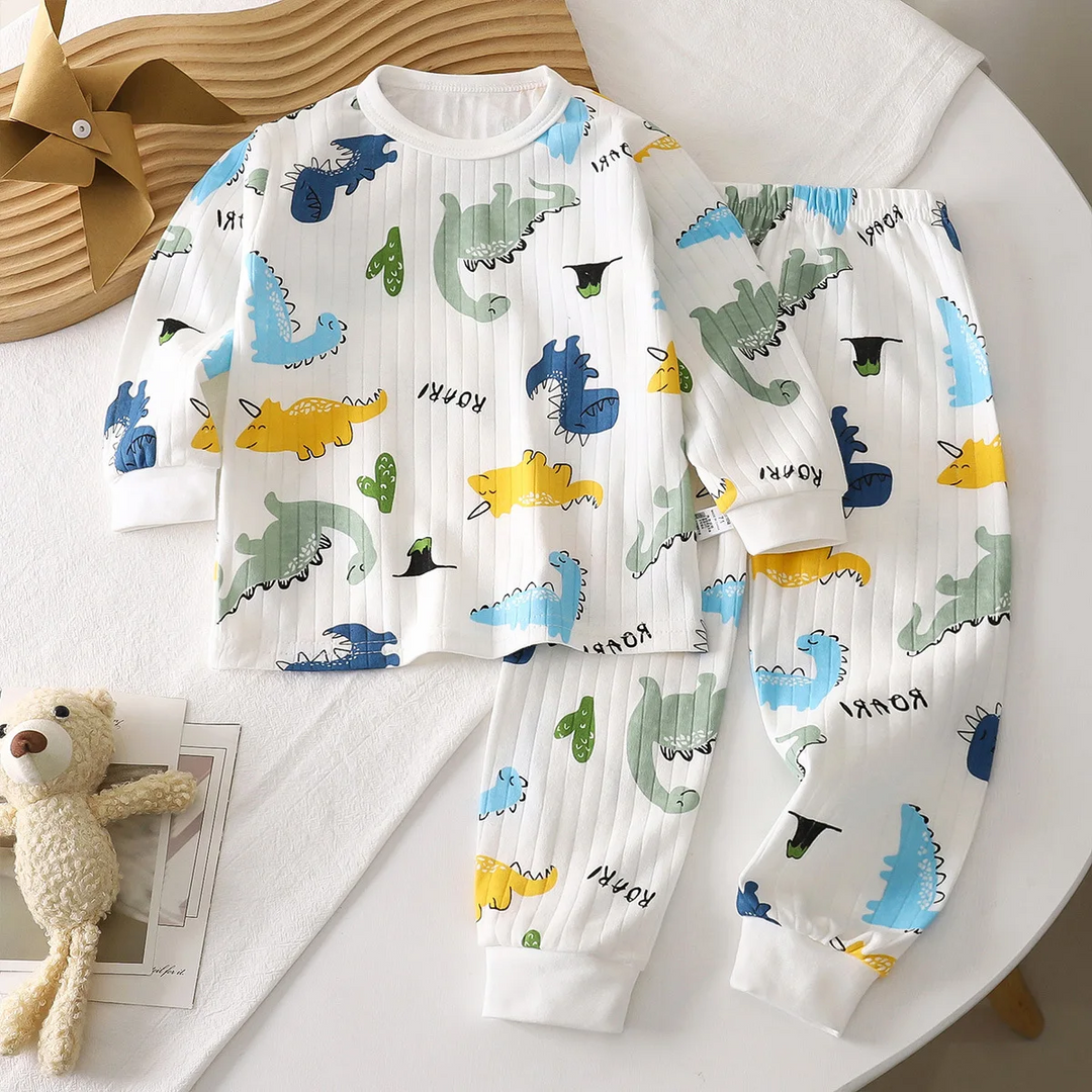 White dinosaur-print pajama set with colorful dinosaurs and matching long pants