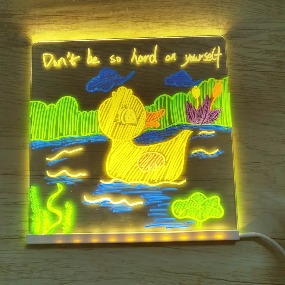 Colorful duck and pond artwork glowing on an acrylic drawing board with a USB cord