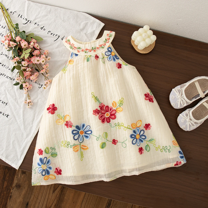 Colorful floral embroidered dress laid flat with a rounded collar and sleeveless cut