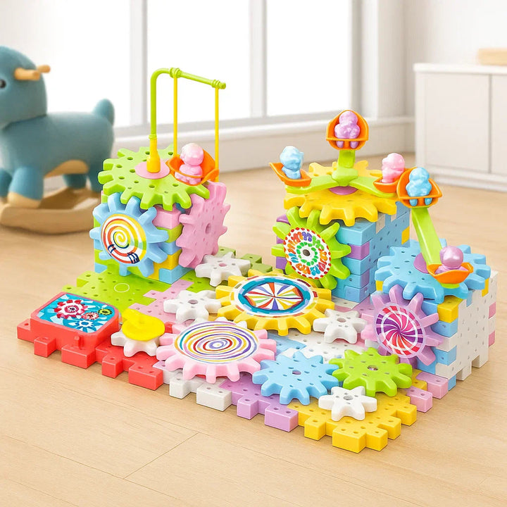 Colorful gear building set with interlocking blocks, towers, swings, and patterned wheels on a table.