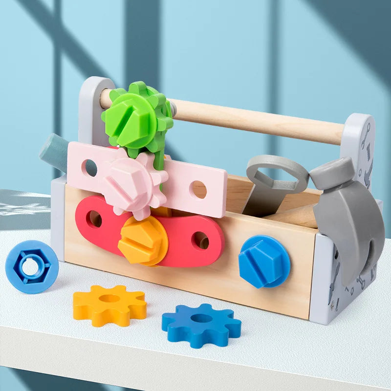 Wooden toolbox with pink, red, and blue assembly pieces and colorful gears attached to the front.