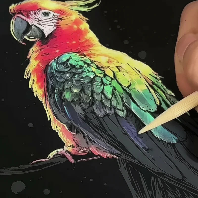 Wooden stylus revealing colorful feather details on a parrot scratch card