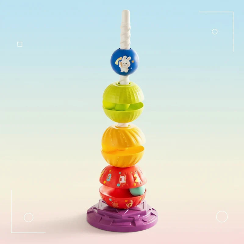 Colorful rotating stacking tower with a spiral post, blue top piece, and purple base