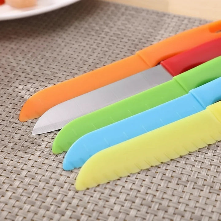 Close-up of colorful serrated plastic knife blades on a woven mat