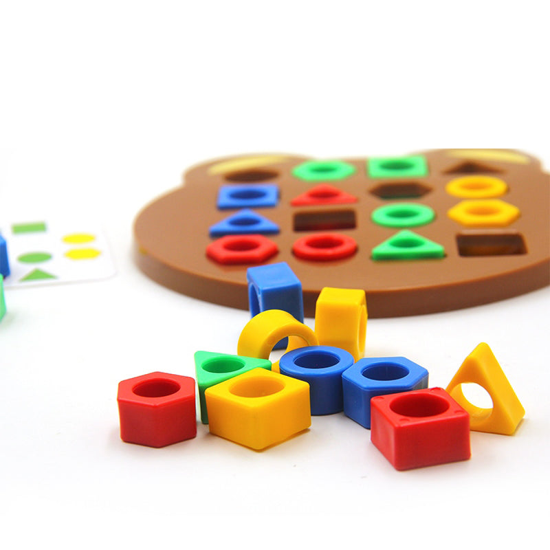 Colorful hollow shape pieces beside a bear puzzle board and pattern card