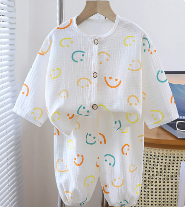 White pajama set with green, yellow and orange smiling face outlines