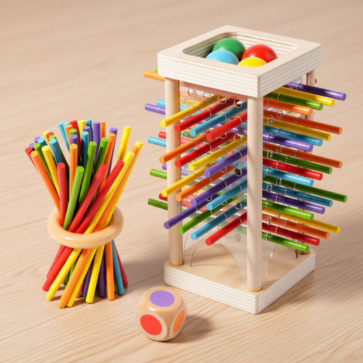 Colorful stick tower beside a wooden ring holding a bundle of sticks and a color die.