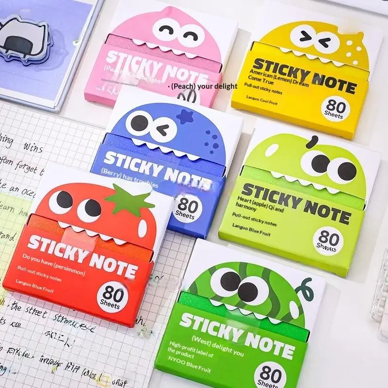 Colorful cartoon sticky note packs arranged on an open notebook