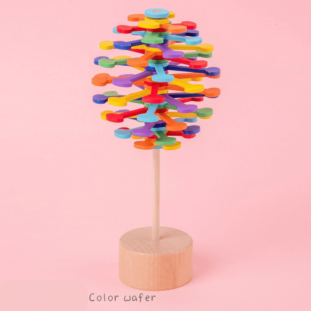 Colorful Waffle wooden rotating lollipop toy on a pink background