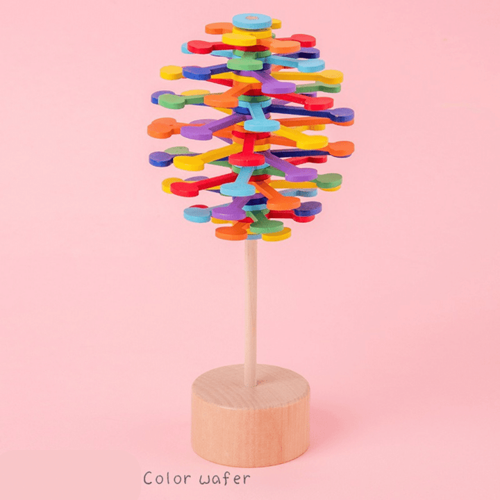 Colorful Waffle wooden rotating lollipop toy on a pink background