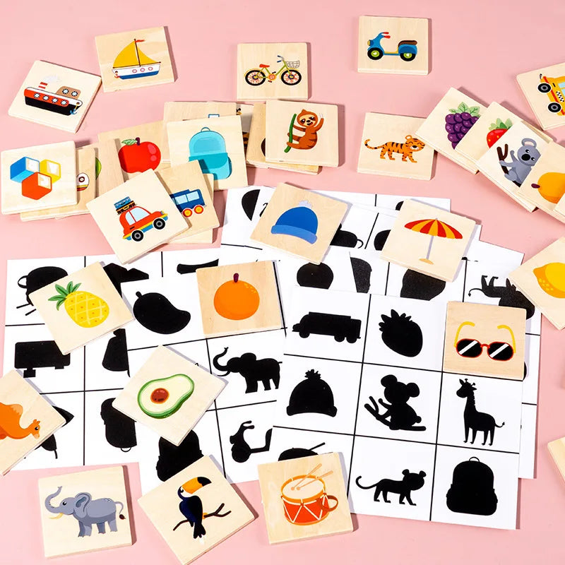 Colorful wooden blocks showing animals, vehicles, and fruit spread over silhouette cards