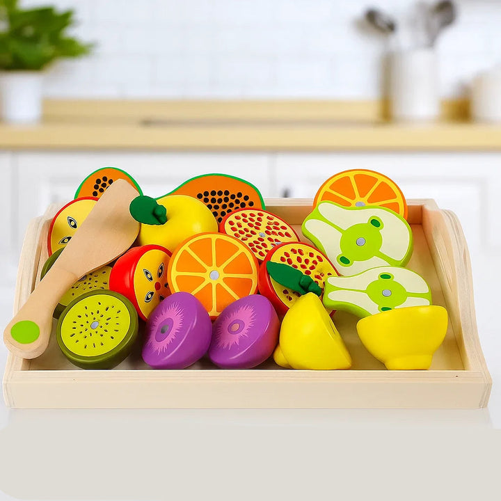Tray of colorful wooden play fruit with sliced kiwi, apple, orange, and pear pieces