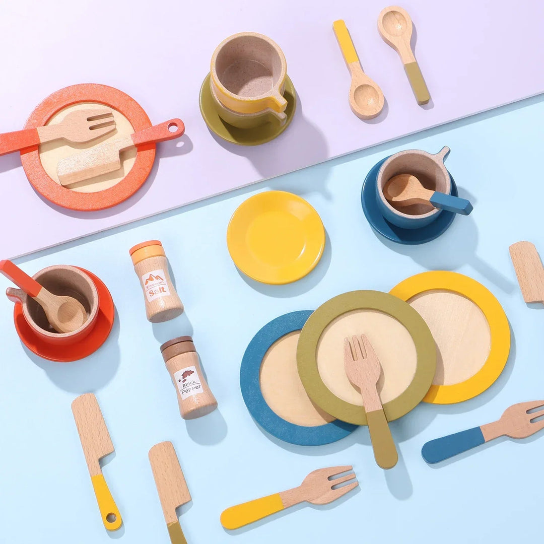 Colorful wooden play cups, plates, utensils, and ingredient jars arranged on a pastel surface
