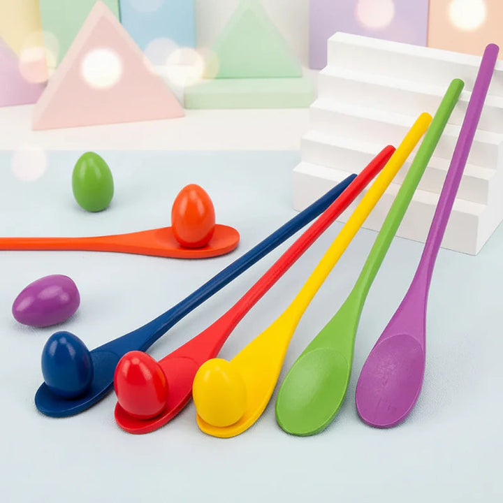 Colorful wooden spoons with matching eggs arranged beside small white steps.