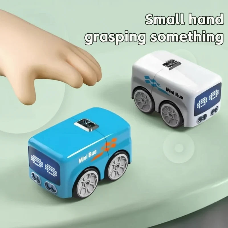 Compact blue and white toy buses beside a hand for scale