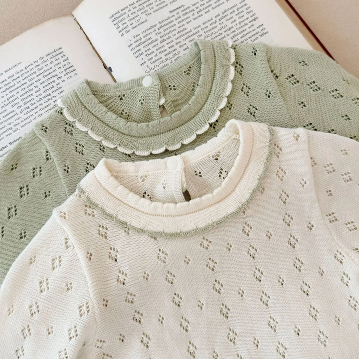 Front view of the ruffled round collars and diamond-pattern knit on green and white dresses