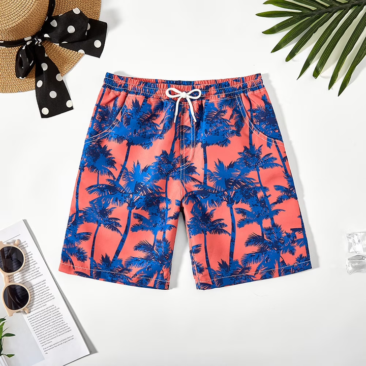 Coral swim trunks with blue palm trees, an elastic waist, and a white drawstring.