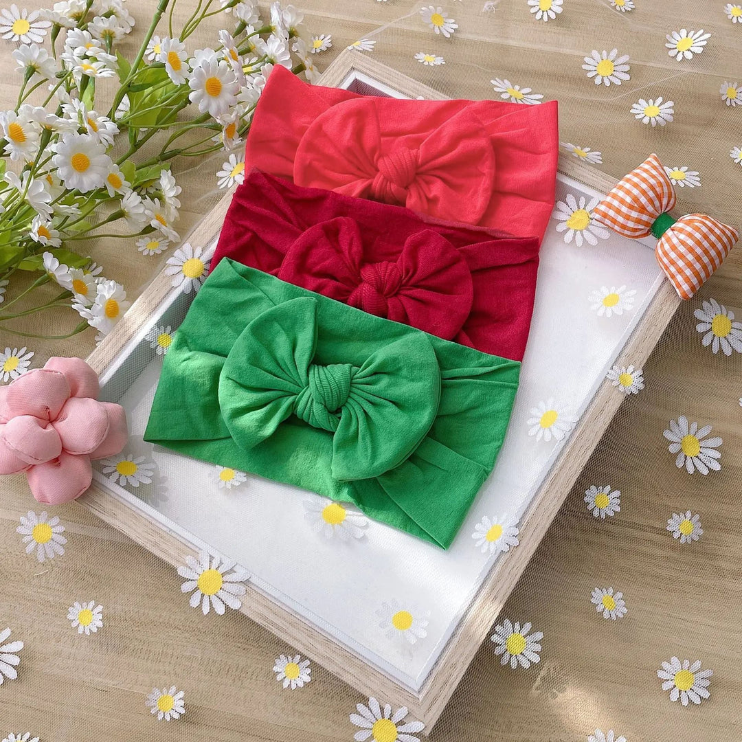 Coral, burgundy, and green bow headbands with gathered fabric bows