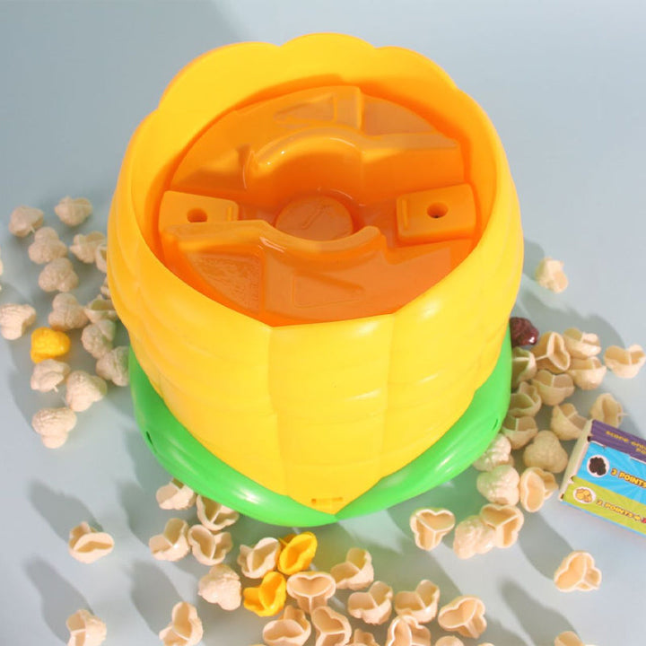 Open top of the corn-shaped game unit showing the internal popping mechanism