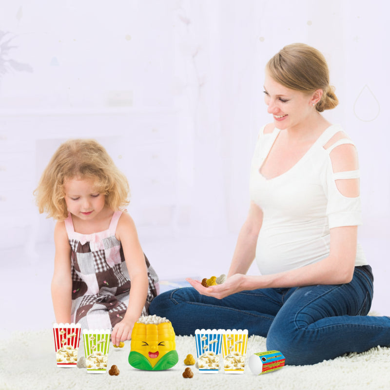 Adult and child playing the popcorn catching game on the floor