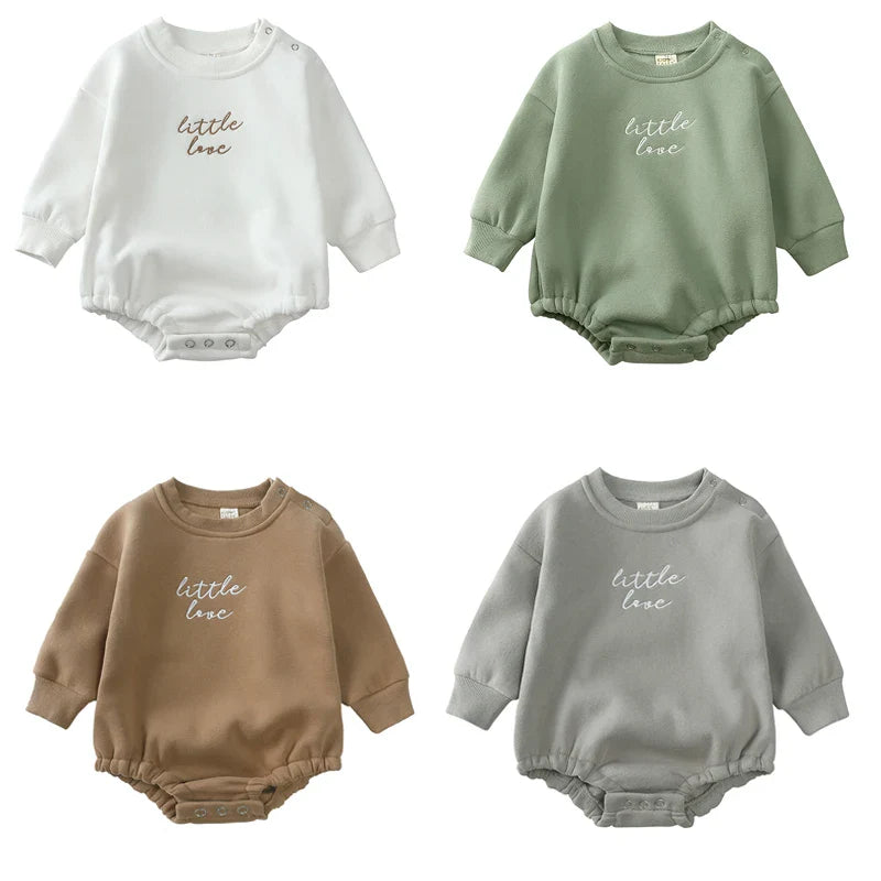 Baby sweater rompers in white, green, brown, and gray with embroidered chest lettering