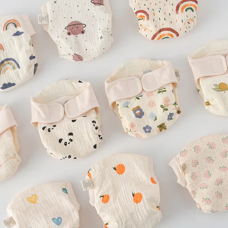 Reusable cotton cloth diapers in assorted rainbow, animal, fruit, and floral prints