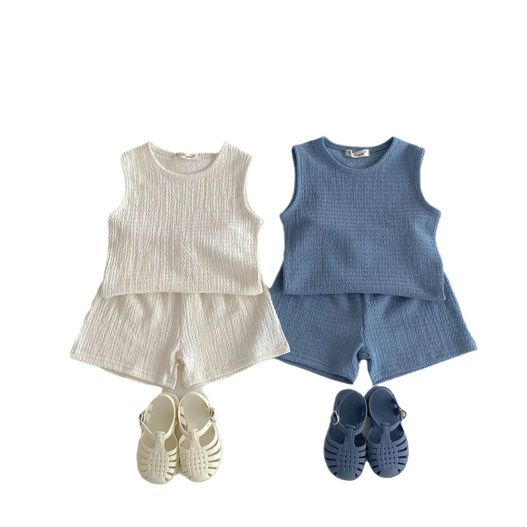 Beige and blue sleeveless tops and shorts displayed side by side with sandals.