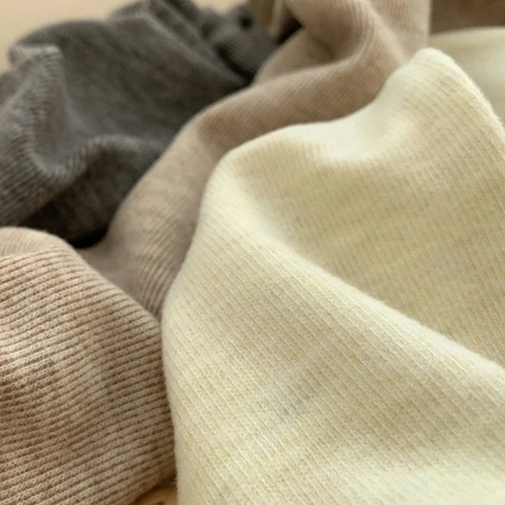 Close-up of fine ribbed fabric in beige, khaki and dark gray