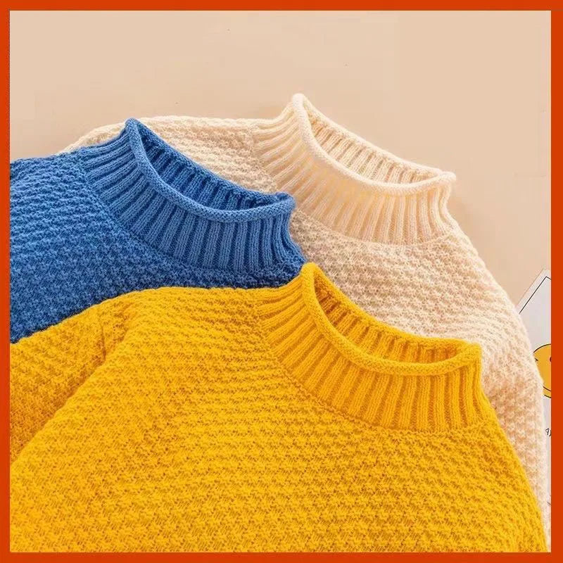 Close-up of ribbed necklines and textured knit on blue, cream white and yellow sweaters.