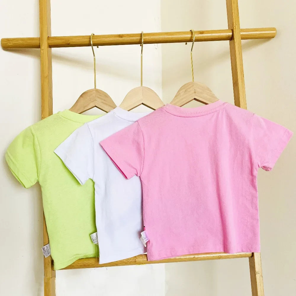 Back views of green, white, and pink short-sleeve kids&