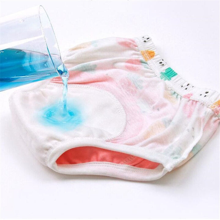 Blue liquid poured onto the inner absorbent area of cotton training pants