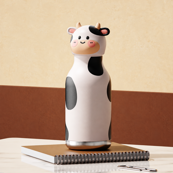 White cow thermos bottle with black spots and an animal-head cap