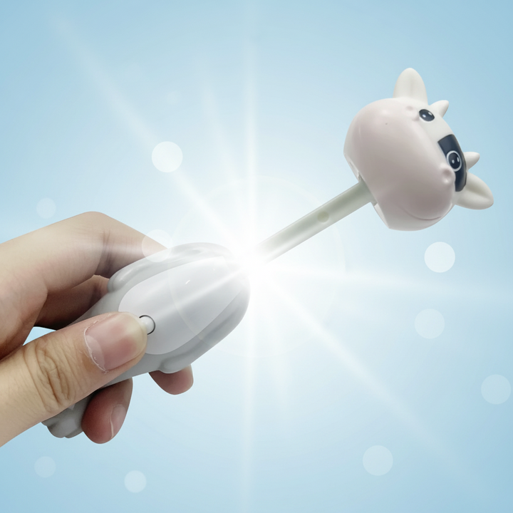 Hand holding a white cow toothbrush with its stem extended and character cover attached