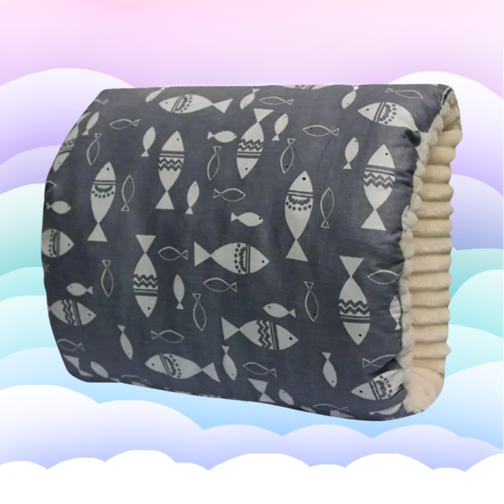 Dark gray nursing pillow with a white fish pattern and cream-colored arm opening.