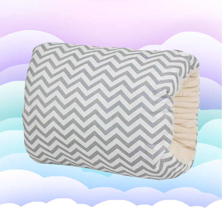 Gray-and-white chevron nursing pillow with an opening that slips over the arm.