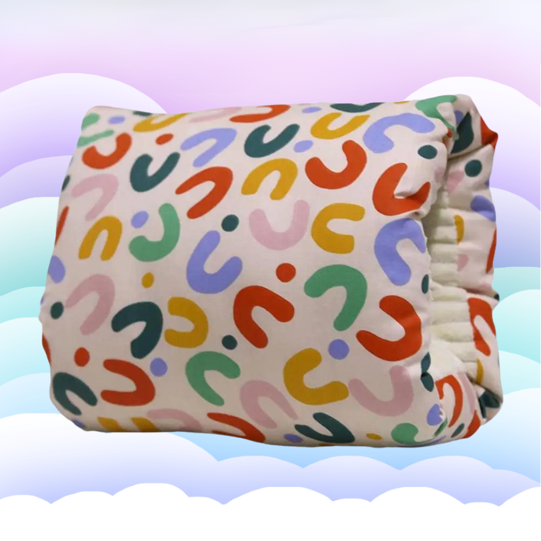 Nursing pillow with a multicolored rainbow pattern and an arm opening.