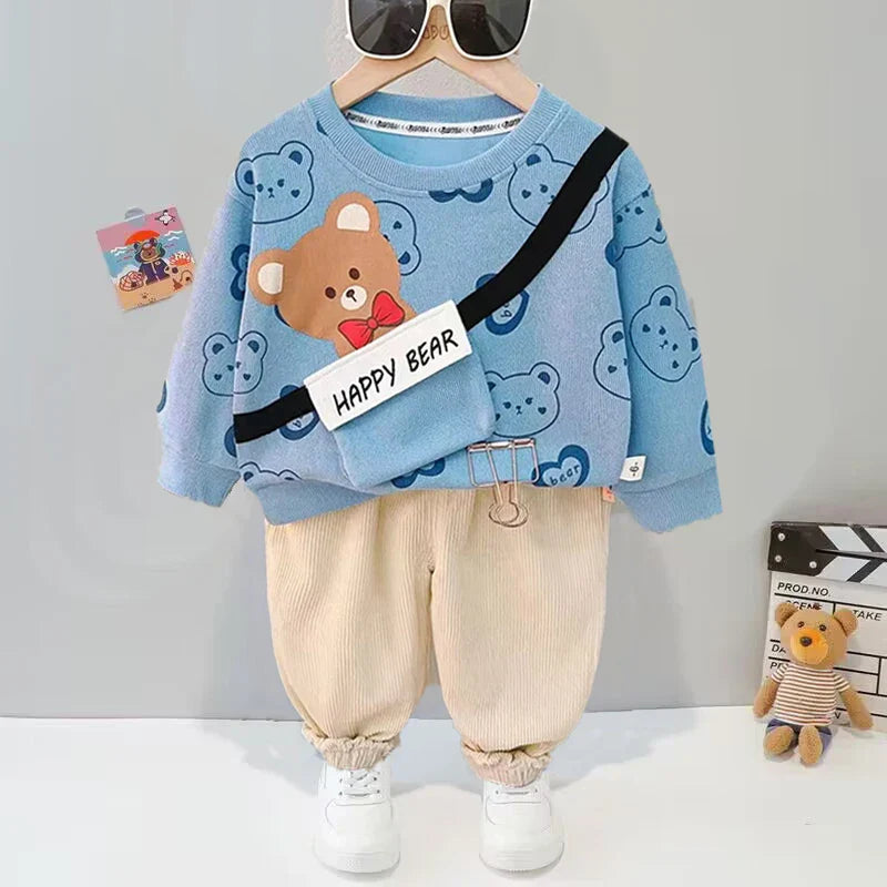 Blue bear-print sweater paired with beige pants with gathered cuffs