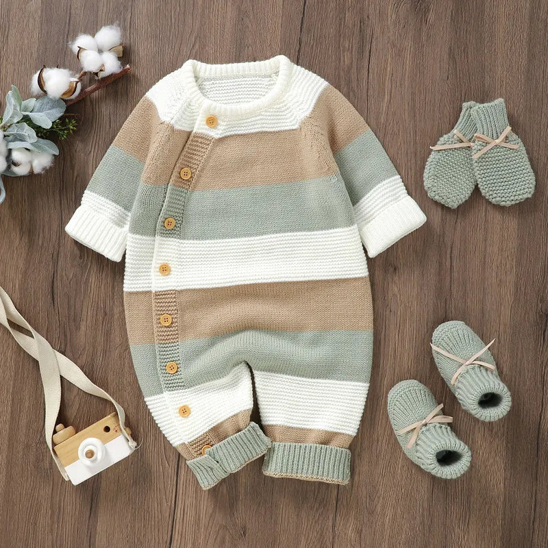 Green, beige and cream striped knit baby romper styled beside matching mittens and booties