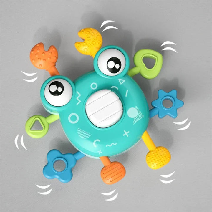 Green crab sensory toy with textured pull pieces and blue star-shaped side details