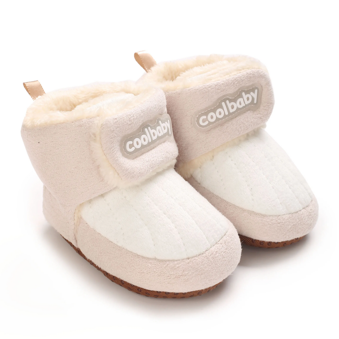 Cream baby boots with quilted toe panels, beige ankle straps and plush lining