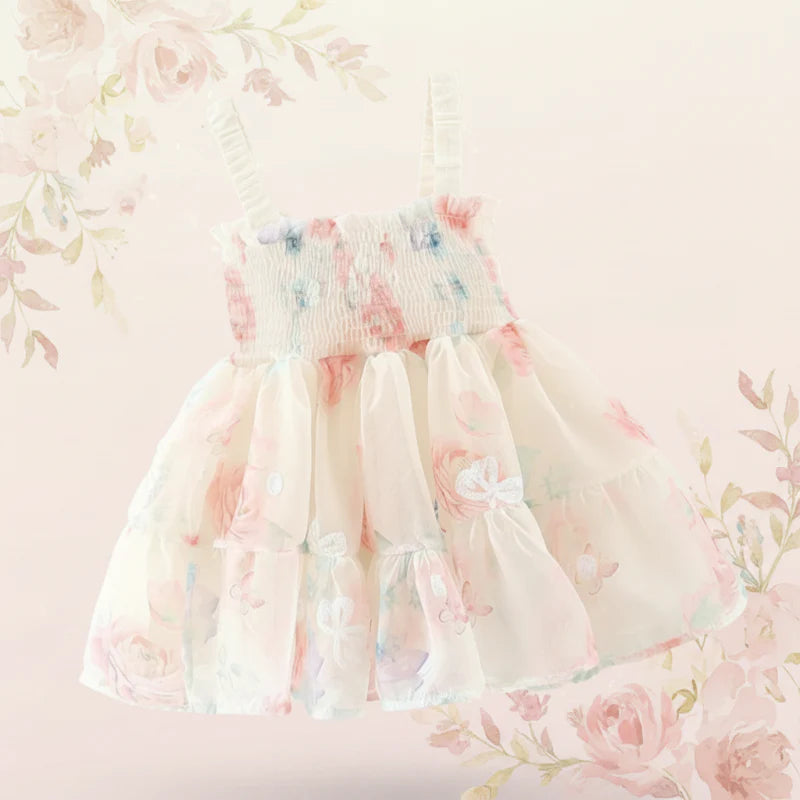 Cream floral baby dress with a smocked bodice and tiered skirt