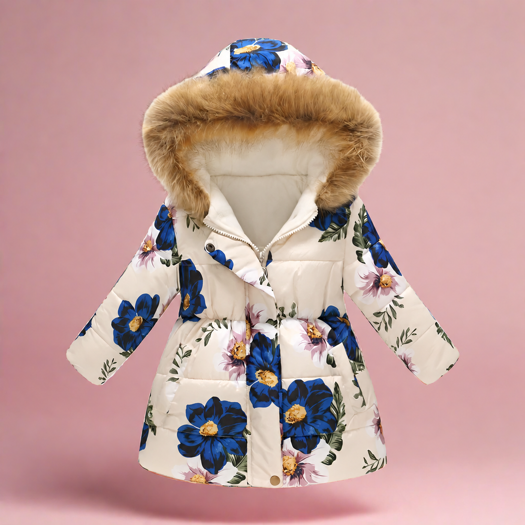 Cream quilted winter coat with blue flowers and fluffy hood trim on a pink background