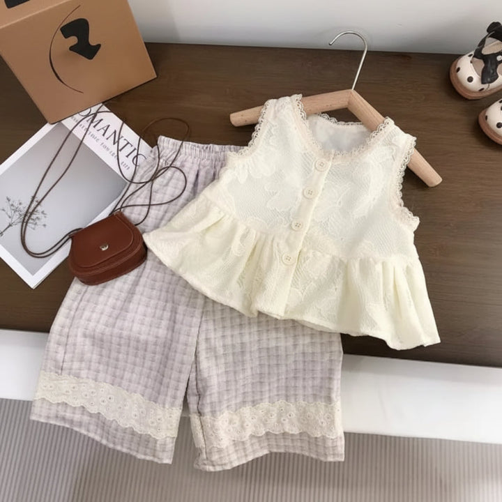 Cream sleeveless button-front top with a ruffled hem and gray checked pants