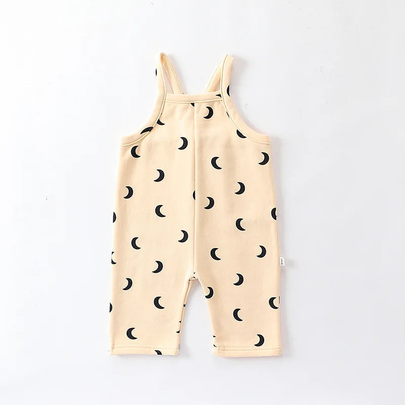 Cream baby overalls with black crescent moons and sleeveless shoulder straps