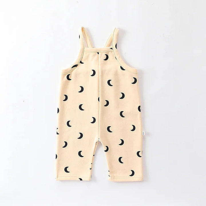 Cream baby overalls with black crescent moons and sleeveless shoulder straps